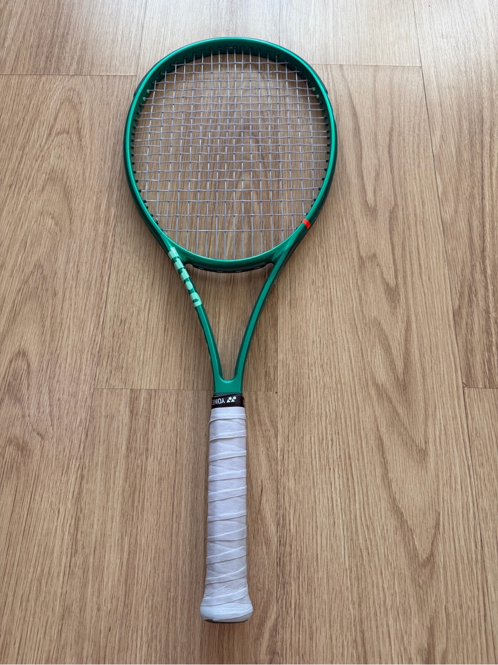 Green Tennis Racket with White Grip